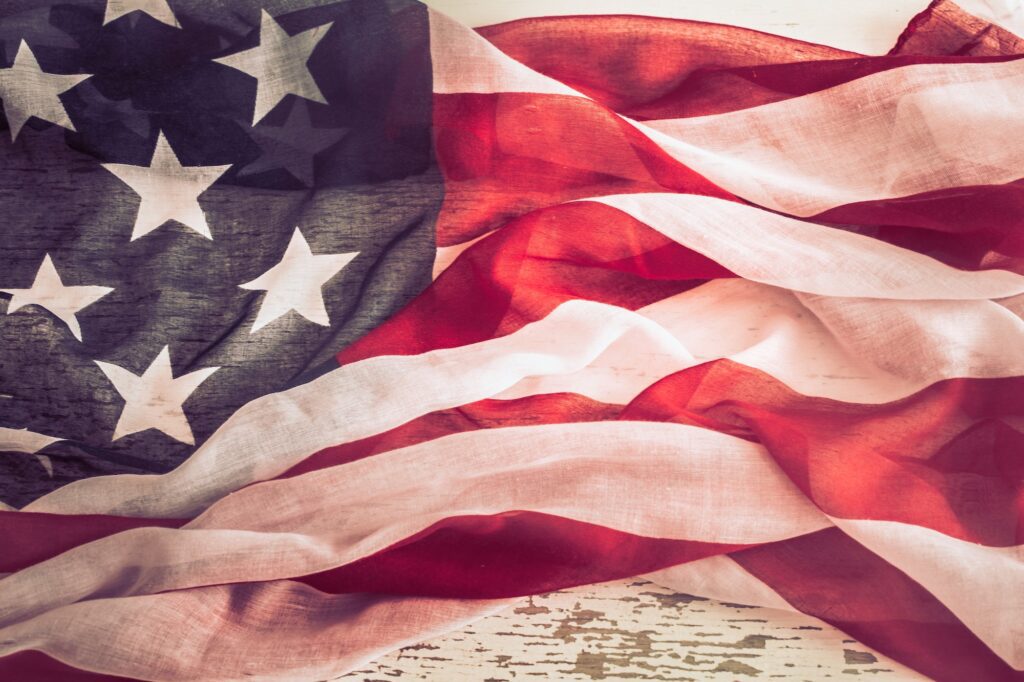 Patriotic symbolism. American flag on wooden background